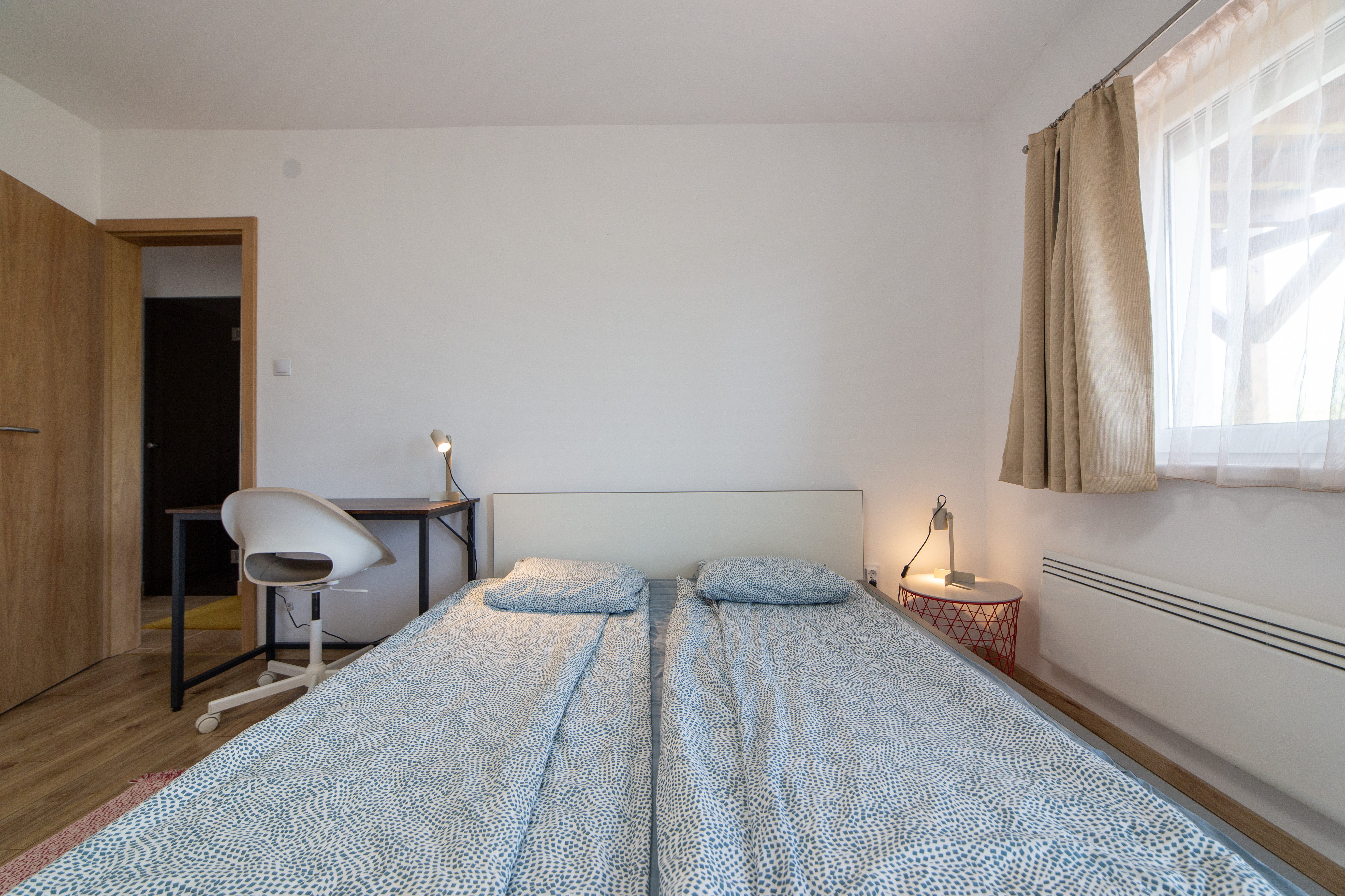 Bedroom 1 — double bed close-up with warm lamp lighting
