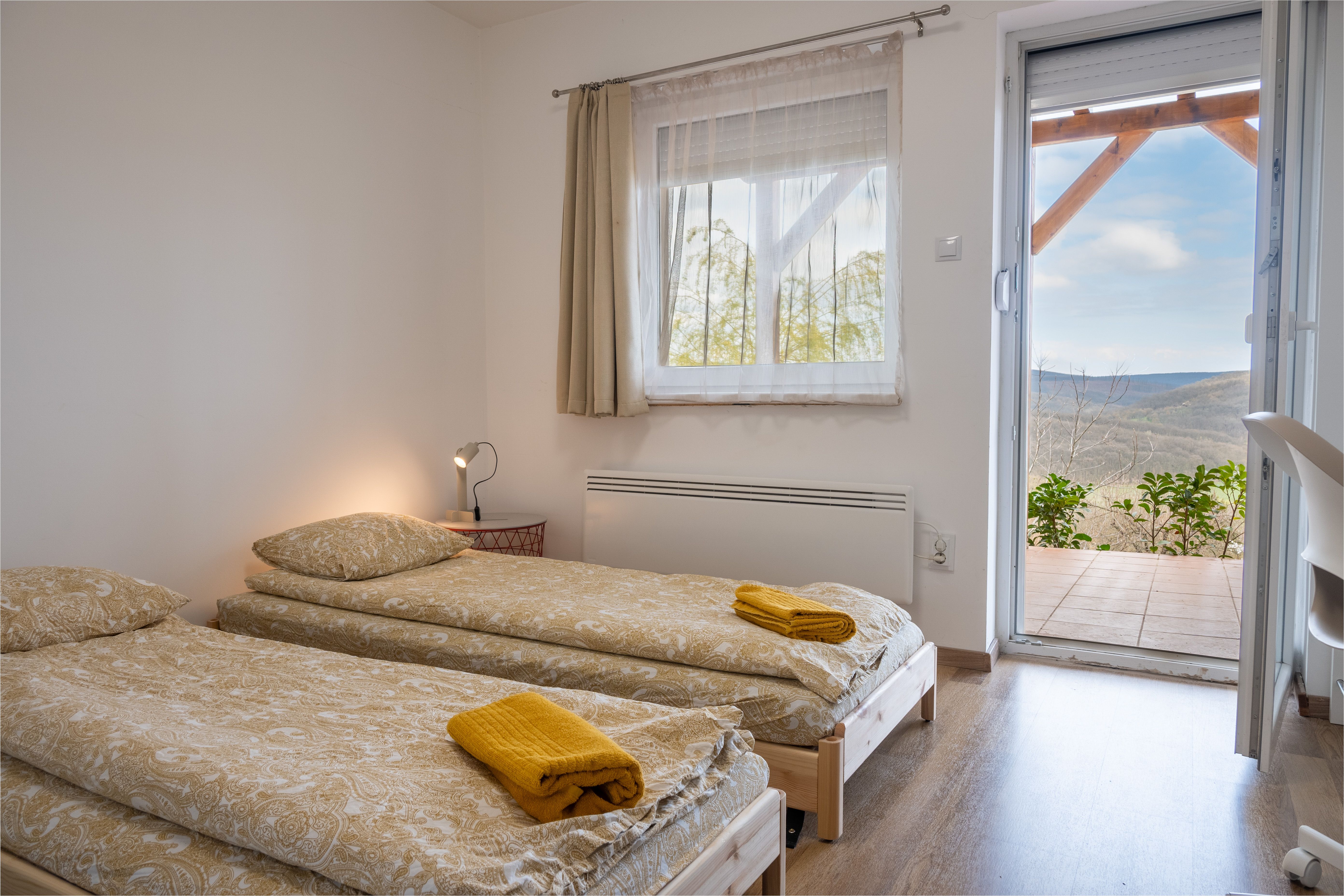 Bedroom 2 — twin beds pushed together with balcony view